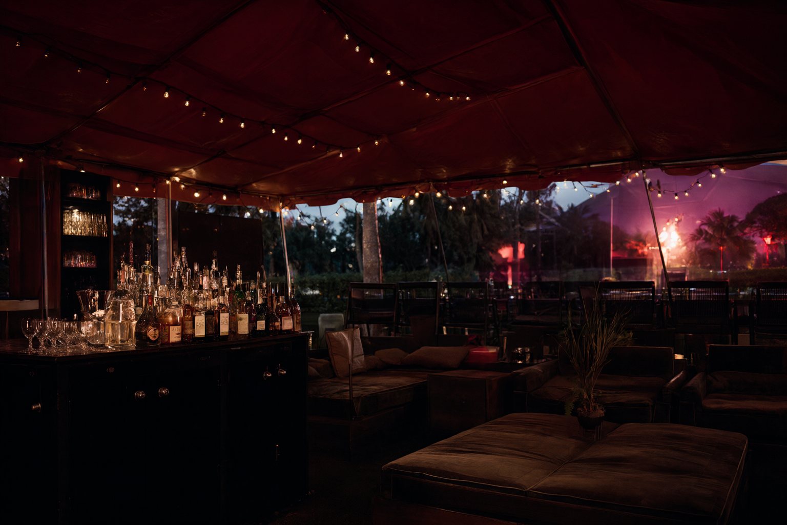 A VIP hospitality lounge at an outdoor festival at dusk
